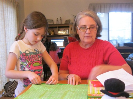 picture of little girl learning to sew from grandma