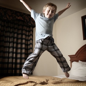 kid jumping on bed picture