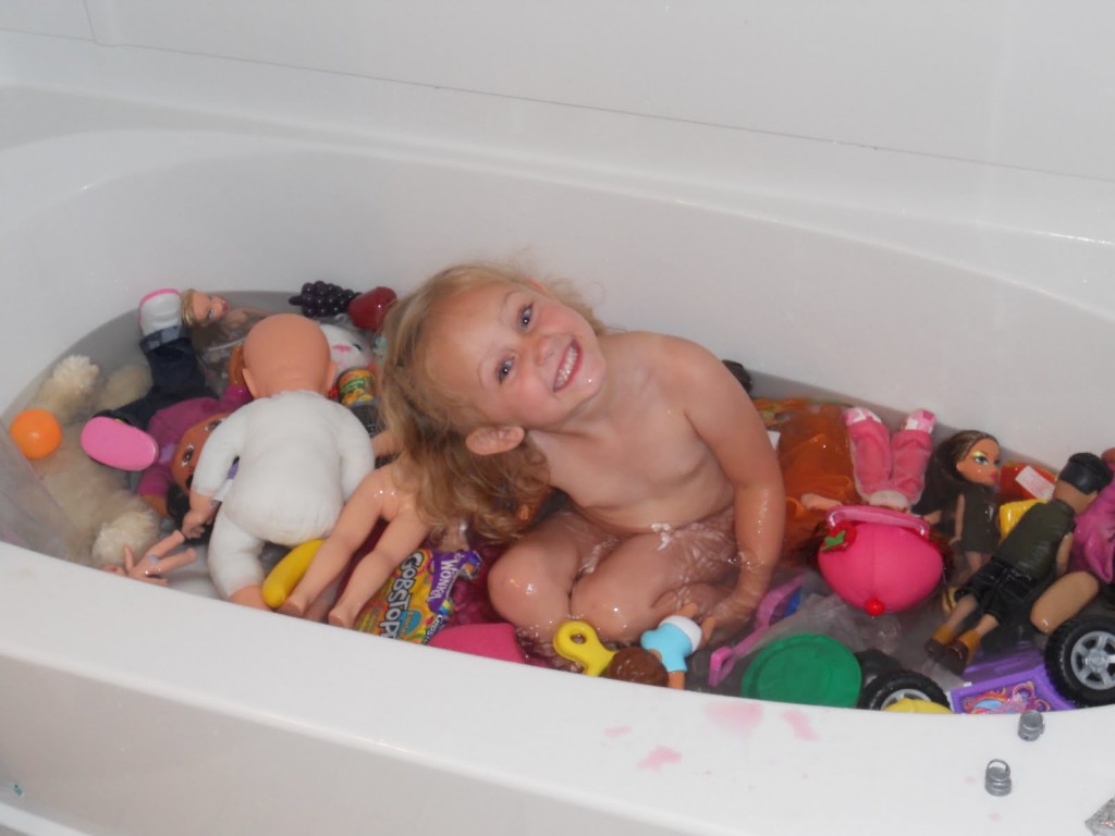  little girl with toys in the tub picture