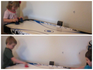 girls and boys playing air hockey