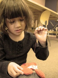 child sewing